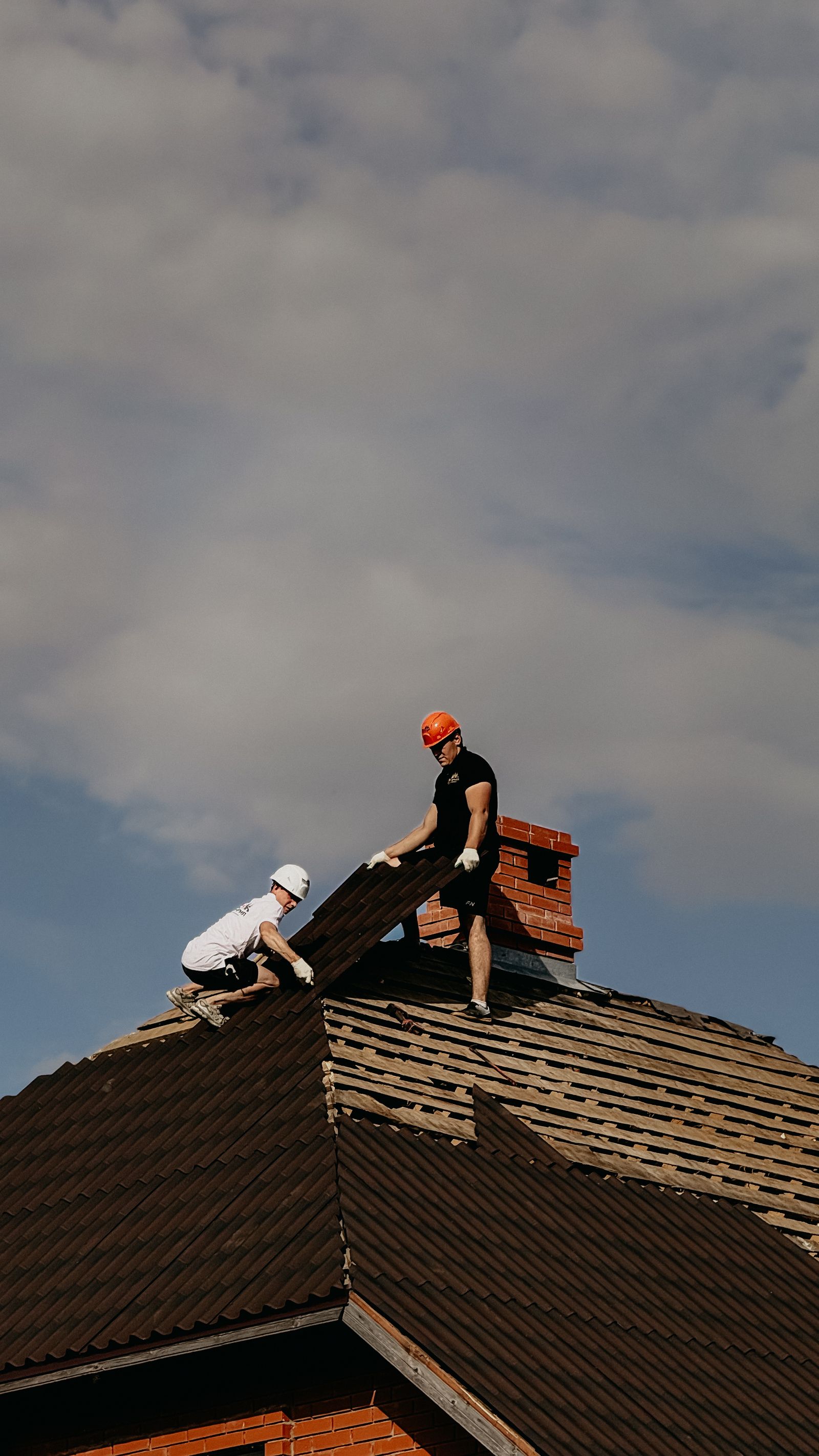 Our roofing crew repairing a storm-damaged roof